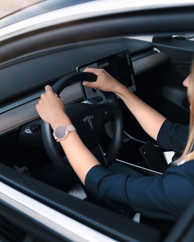 Woman Driving A Tesla Car