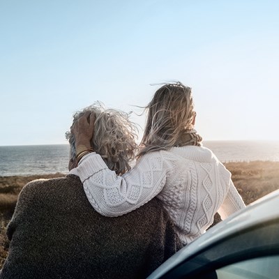 Couple on car with seaview
