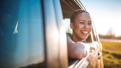 Woman smiling out of car window 