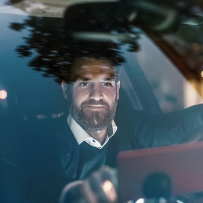 Business men in leasecar at night