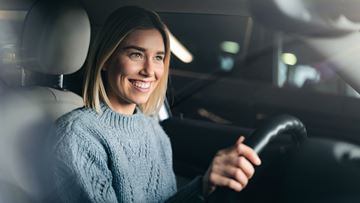 Young Woman Blond Hair Behind Steering Wheel
