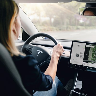 Woman Driving A Tesla Car Inside View