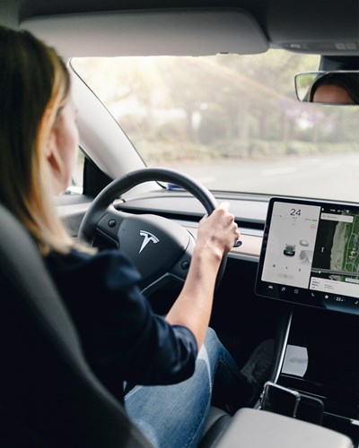 Woman Driving A Tesla Car Inside View