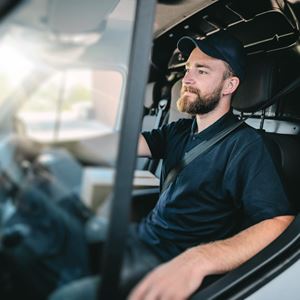 Young Man Behind The Wheel Of A Delivery Van