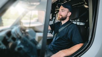 Young Man Behind The Wheel Of A Delivery Van