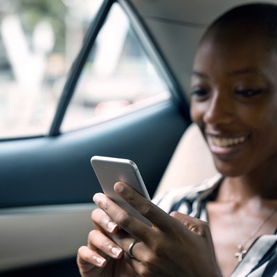 Women in leasecar on her phone