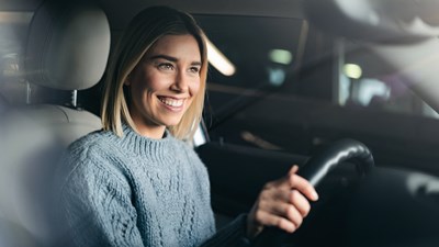 Young Woman Blond Hair Behind Steering Wheel