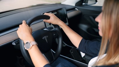 Woman Behind Steering Wheel Tesla Car